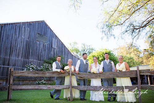 Bridal party in front of a shed.
