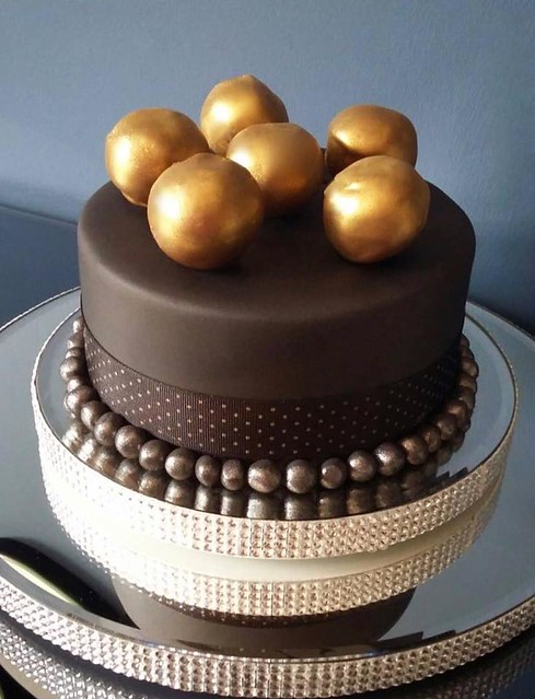 Lemon drizzle cake with lemon buttercream. The balls on top are actually chocolate fudge cake pops by Cake beautiful