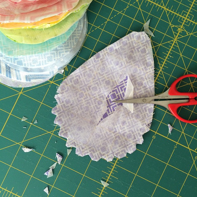 Once I've sewn each raindrop and fusible interfacing together (right side and sticky side) I clip the rounded part, clip the point, then cut a small hole in the interfacing. Then I'll turn the raindrops right side out.
