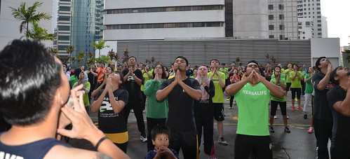 Participants exercising to Herbalife Fit Total Body workout video featuring Samantha Clayton