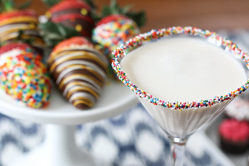 birthday cake martini with sprinkles in a glass and dipped strawberries