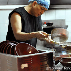 Making tonkotsu soup noodles at Gumshara Ramen in Eating World Food Court, Haymarket