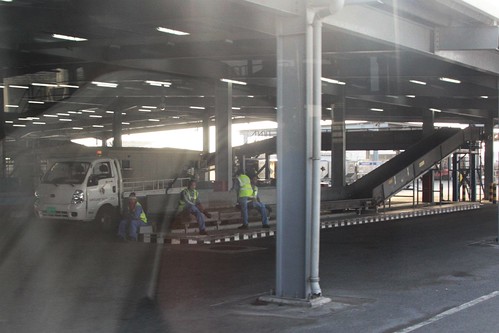 Baggage handlers avoid the harsh desert heat