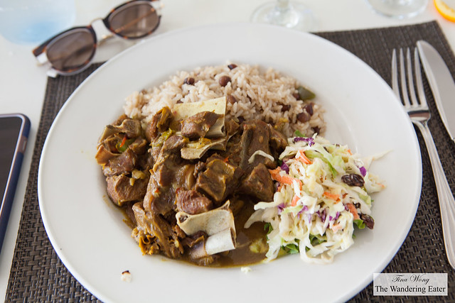Curry goat with rice and peas and cole slaw