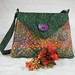 KARIN  $55 - shoulder bag; 10" wide at top, 12" wide at bottom, 9"tall, 3"deep;  4 interior pockets 4"-5" wide by 4" tall; pen pocket; 2 exterior pockets 6" wide by 5" tall; magnetic closure; decorative button; handle drop 14"; rigid bottom insert