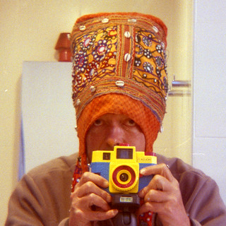 reflected self-portrait with Holga 120 CFN camera and tall hat