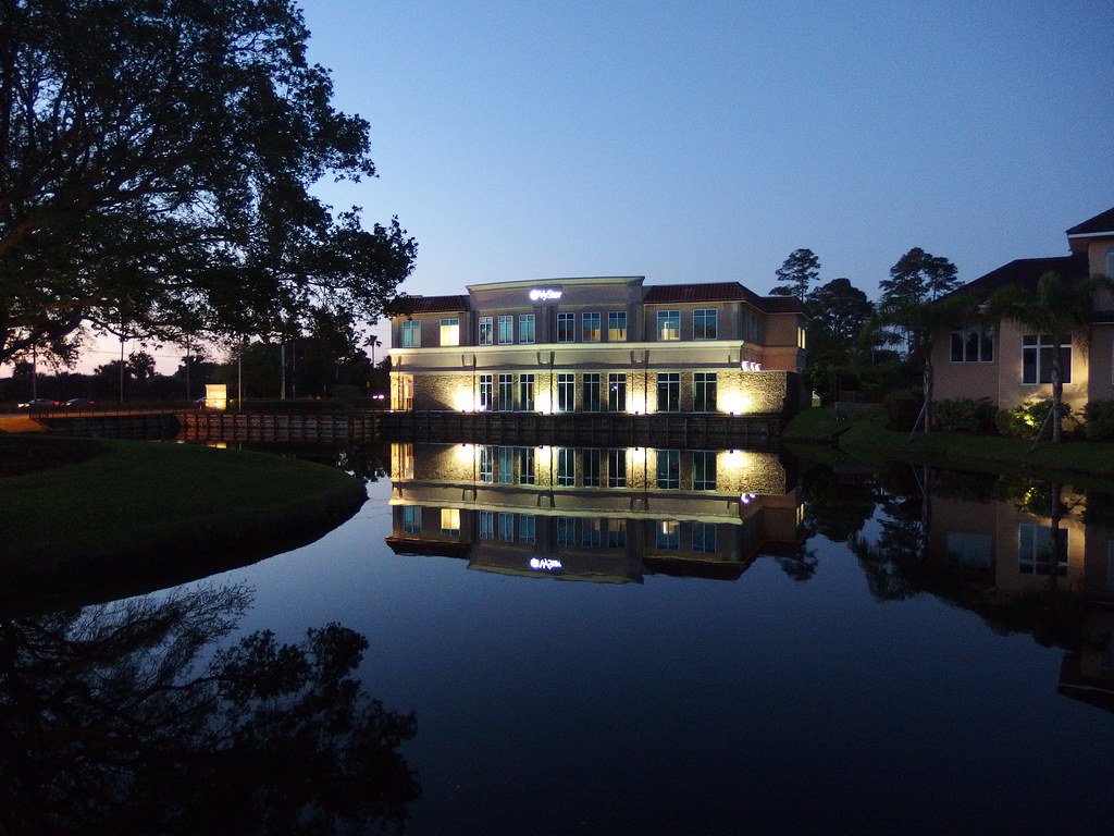 Picture of a building reflected in a pond taken before dawn on an Olympus XZ-10