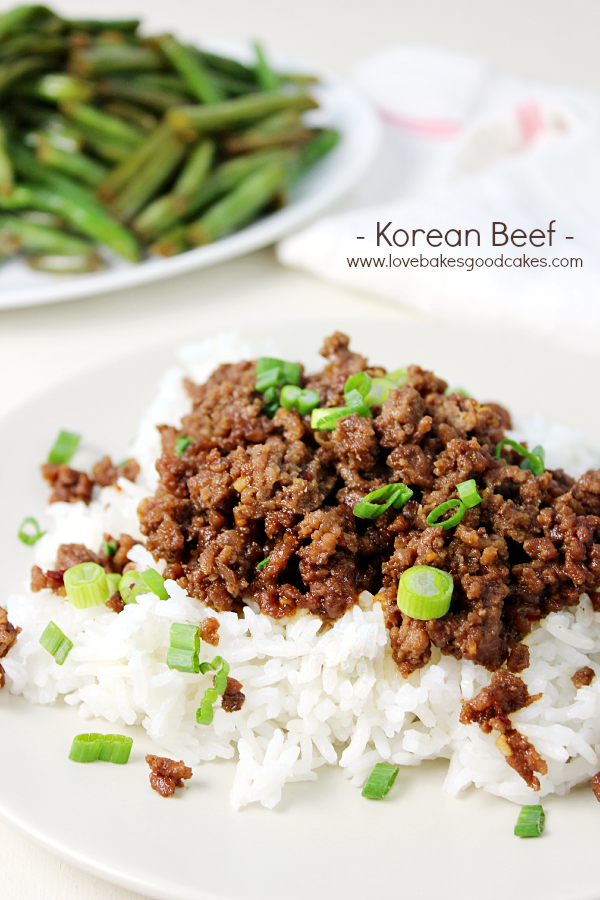 Korean Beef with white rice on a plate with green beans.