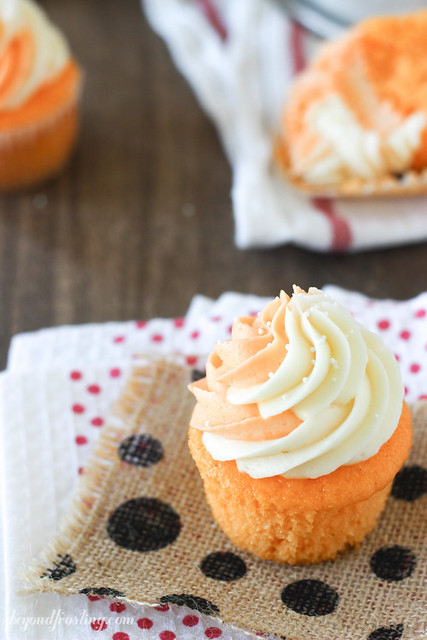These Orange Cream Pop Cupcakes will make your tastebuds go wild! These orange flavored cupcake are topped with a vanilla buttercream frosting. Plus a bonus swirl of orange cream flavored buttercream too! 
