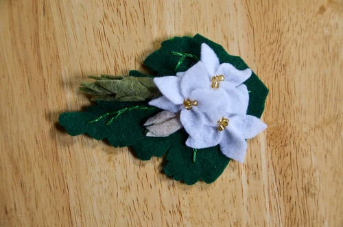 Place flower bud with other flowers hiding the bottom stitches