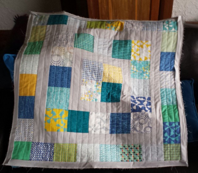 Baby quilt quilted and bindings sewn onto front. Now I just need more grey thread so I can hand sew them on the back.