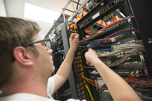 A technician installing cables at Pine Net Telephone and internet stations