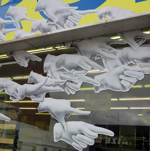 A multitude of pointing hands in a store display in Mons, Belgium