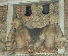 a knight, his lady, three cherubs, a skull