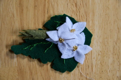 Sew the third flower to the side of the asparagus, 2 stitches through the gold beads