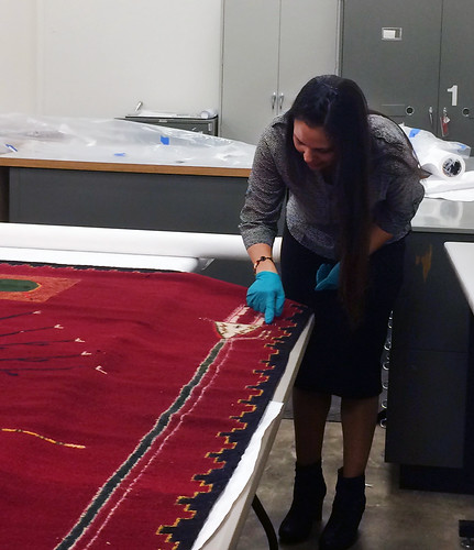 Nanebah Nez examines the intricate weaving of “Sandpainting of the Arrow People”