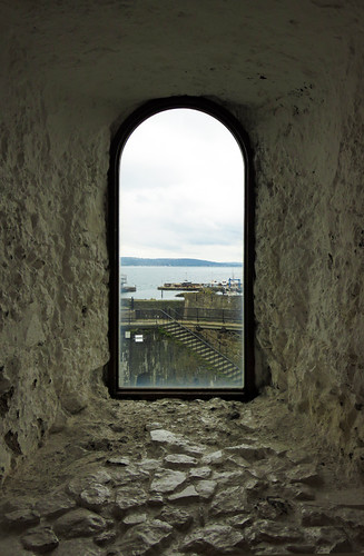 A window looking out to the sea in the medieval castle of Carrickfergus along the Coastal Causeway Route of Ireland, UK