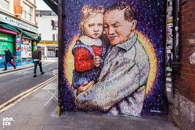 Brick Lane Street Art by JimmyC who paints a portrait of Joe's Kid cafe owner aged 3 with grandfather.