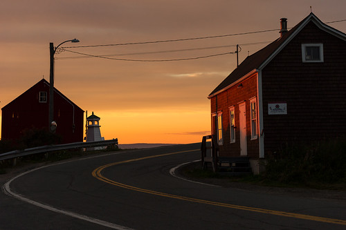 hallsharbour novascotia canada mauricewoodworth parkers general store sunset kingscounty bayoffundy atlantic pastel colours clouds curve road lighthouse village fishing backlit