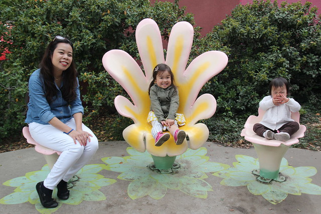Sitting on the flower chairs at Fairyland