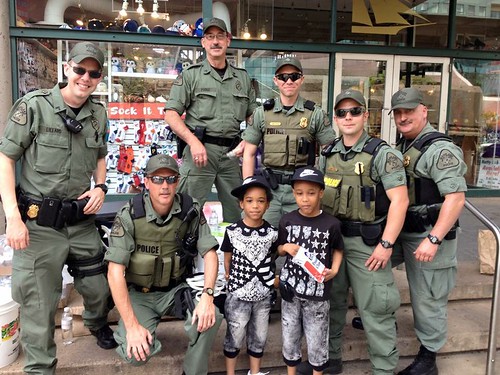 NRP officers with children in the Inner Harbor 